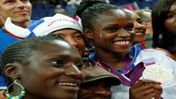 FILE PHOTO: France's Emilie Gomis celebrates silver medal with her family during victory ceremony at the North Greenwich Arena during the London 2012 Olympic Games August 11, 2012. REUTERS/Mike Segar (BRITAIN - Tags: OLYMPICS SPORT BASKETBALL)/File Photo