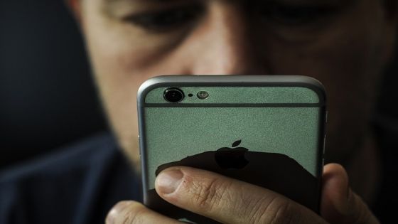 A man is seen using an Apple iPhone on October 1, 2018 Apples latest realese of its mobile device operating system, version 12 has been plagued by bugs which can send messages to unintended recipients due to a feature which bundles same users who have multiple phone numbers. (Photo by Jaap Arriens/NurPhoto via Getty Images)