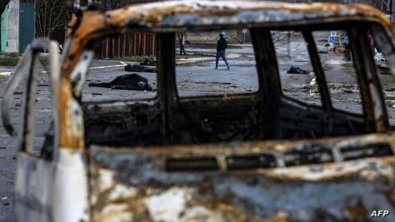 EDITORS NOTE: Graphic content / TOPSHOT - A man walks on a street with several dead bodies on the ground a street in Bucha, northwest of Kyiv, as Ukraine says Russian forces are making a "rapid retreat" from northern areas around Kyiv and the city of Chernigiv, on April 2, 2022. - The bodies of at least 20 men in civilian clothes were found lying in a single street Saturday after Ukrainian forces retook the town of Bucha near Kyiv from Russian troops, AFP journalists said. Russian forces withdrew from several towns near Kyiv in recent days after Moscow's bid to encircle the capital failed, with Ukraine declaring that Bucha had been "liberated". (Photo by RONALDO SCHEMIDT / AFP)