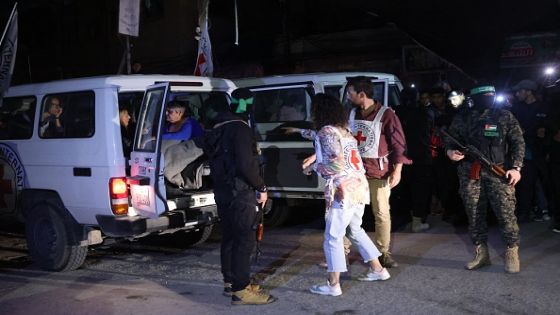 Members of the Red Cross prepare to transport hostages released by Hamas in Rafah, in the southern Gaza Strip on November 28, 2023. Hamas handed over several hostages to the Red Cross in Gaza, an AFP journalist saw, part of an exchange under the terms of an extended truce in the Israel-Hamas war. The hostages, all women, were handed over by masked and armed fighters to Red Cross officials in Rafah, near the border with Egypt, the journalist said. (Photo by AFP) (Photo by -/AFP via Getty Images)