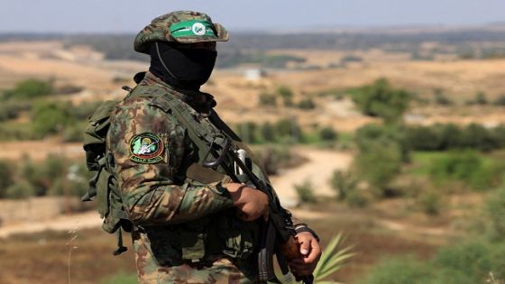 A Palestinian fighter of the al-Qassam Brigades, the armed wing of the Hamas movement, takes part in a military parade to mark the anniversary of the 2014 war with Israel, near the border in the central Gaza Strip on July 19, 2023. (Photo by Mahmud HAMS / AFP)