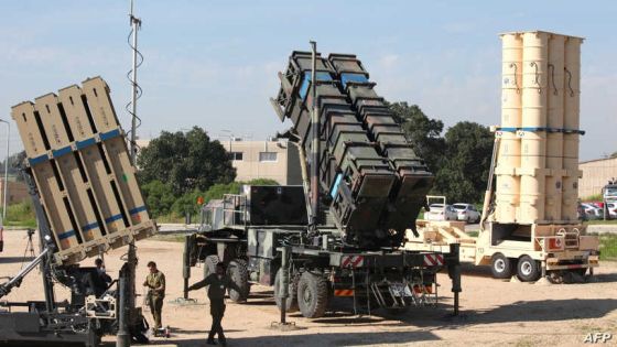 Israeli soldiers walk near an Israeli Irone Dome defence system (L), a surface-to-air missile (SAM) system, the MIM-104 Patriot (C), and an anti-ballistic missile the Arrow 3 (R) during Juniper Cobra's joint exercise press briefing at Hatzor Israeli Air Force Base in central Israel, on February 25, 2016. - Juniper Cobra, is held every two years where Israel and the United States train their militaries together to prepare against possible ballistic missile attacks, as well as allowing the armies to learn to better work together. (Photo by GIL COHEN-MAGEN / AFP)