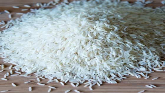 TORONTO, ONTARIO, CANADA - 2015/03/30: Small pile of long grain white rice over a wooden surface with natural illumination showing highlights and shadows, basmati rice in cutting board. (Photo by Roberto Machado Noa/LightRocket via Getty Images)