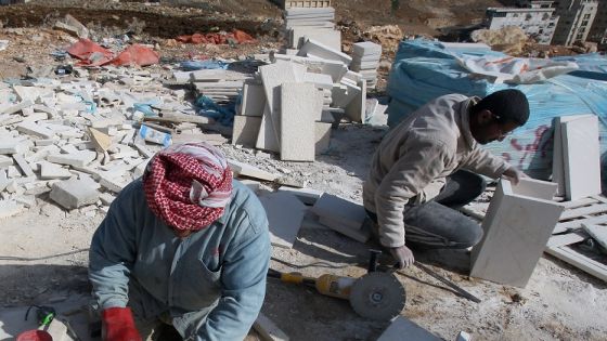 Works cut limestones at a site where an apartment building is being constructed in Amman on January 8, 2009. Jordanians are snapping up houses despite soaring prices and warnings from analysts in the six-billion-dollar housing sector that a property "disaster" is looming. New units are being constructed as a demand for housing is expected to rise in Jordan over 2009. AFP PHOTO/AWAD AWAD (Photo by AWAD AWAD / AFP) (Photo by AWAD AWAD/AFP via Getty Images)