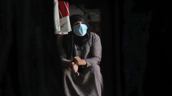 An Iraqi Kurdish clothing merchant, clad in protective mask due to the COVID-19 coronavirus pandemic, sits in her shop in Arbil, the capital of the autonomous Kurdish region of northern Iraq on June 4, 2020. (Photo by SAFIN HAMED / AFP) (Photo by SAFIN HAMED/AFP via Getty Images)