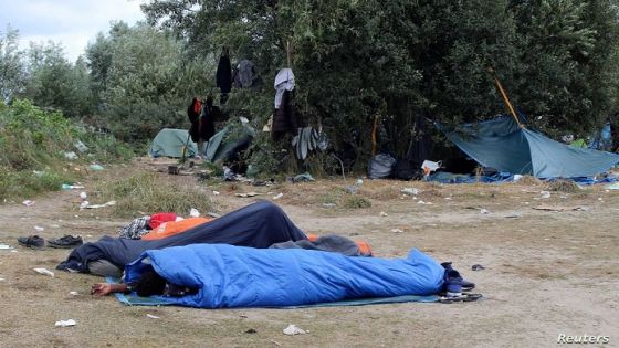 Migrants sleep in sleeping bags at a makeshift migrant camp near the hospital in Calais, France, September 10, 2021. REUTERS/Forrest Crellin