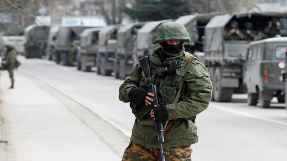 FILE PHOTO: Armed servicemen wait in Russian army vehicles outside a Ukranian border guard post in the Crimean town of Balaclava March 1, 2014. REUTERS/Baz Ratner/File Photo