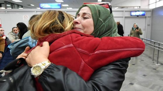 A student (L) evacuated from Ukraine is embraced by a relative upon her arrival at the Tunis-Carthage airport on March 1, 2022. (Photo by FETHI BELAID / AFP)