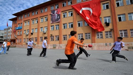 Students plays football at their school's playground during the first day of school on September 16, 2013 at a primary school at Bayrampasa district in Istanbul. AFP PHOTO/OZAN KOSE (Photo credit should read OZAN KOSE/AFP/Getty Images)