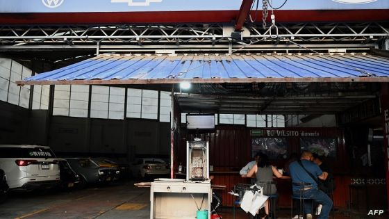 People eat at El Vilsito taqueria in the Navarte neighborhood in Mexico City on June 22, 2023. El Vilsito, a mechanic shop by day and taqueria by night, has become one of the favorite destinations for gastronomic tours in Mexico City. (Photo by ALFREDO ESTRELLA / AFP)