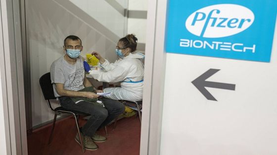 FILE PHOTO: A man receives a second dose of the Pfizer-BioNTech vaccine against the coronavirus disease (COVID-19) at the hall three of the Belgrade Fair, in Belgrade, Serbia, April 13, 2021. REUTERS/Marko Djurica/File Photo