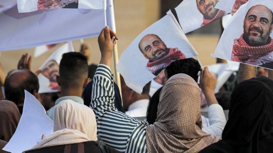 Demonstrators hold up images of late Palestinian activist Nizar Banat, who died in late June during a violent arrest by Palestinian Authority security forces, as they march during a protest in the city of Hebron in the occupied West Bank on July 13, 2021. (Photo by Ahmad GHARABLI / AFP)