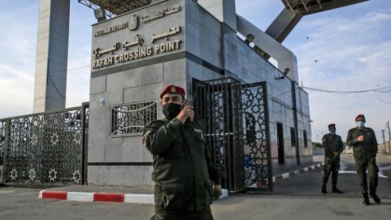 Members of the Palestinian security forces loyal to Hamas, mask-clad due to the coronavirus pandemic, stand guard at the Rafah border crossing with Egypt, in the southern Gaza Strip, on February 9, 2021, which reopened after an Egyptian announcement to let through incoming traffic until further notice. - Egypt on February 9 opened its border crossing "indefinitely" with Gaza -- the Israeli-blockaded Palestinian enclave -- against the backdrop of Palestinian political unity talks in Cairo continue, a security source said. (Photo by SAID KHATIB / AFP)