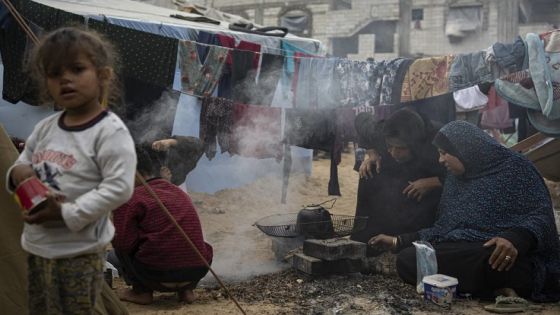 Palestinians displaced by the Israeli bombardment of the Gaza Strip cook at the makeshift tent camp in the Muwasi area on Thursday, Dec. 28, 2023. (AP Photo/Fatima Shbair)