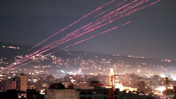 Gunfire lights the sky over Beirut as the clock strikes midnight and 1999 begins. Many Lebanese celebrated the start of the last year of the century by shooting guns into the air. (Photo by JOSEPH BARRAK / AFP)