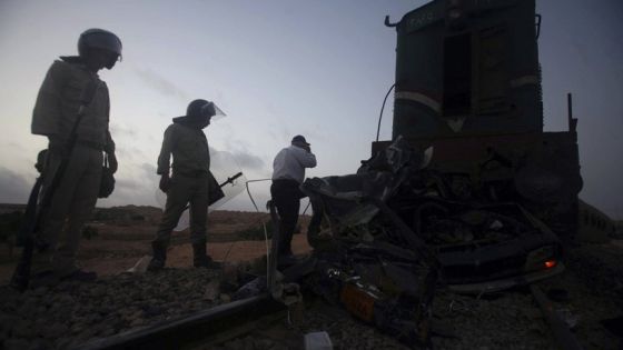 Egyptian policemen inspect the wreckage of a train crash near the Mediterranean city of Marsa Matrouh 430 km (270 miles) northwest of Cairo July 16, 2008. Forty people were killed and 40 injured when a train crashed into several vehicles on a railway crossing in northern Egypt on Wednesday, state news agency MENA said. REUTERS/Amr Dalsh (EGYPT)