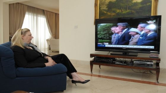 Yasser Arafat's widow, Suha Arafat, watches the television reports of the exhumation of her husband at her home in Sliema in Malta on November 27, 2012. The remains of iconic Palestinian leader Yasser Arafat were exhumed on Tuesday, eight years after his death, with experts set to test for signs that he was poisoned. AFP PHOTO / MATTHEW MIRABELLI