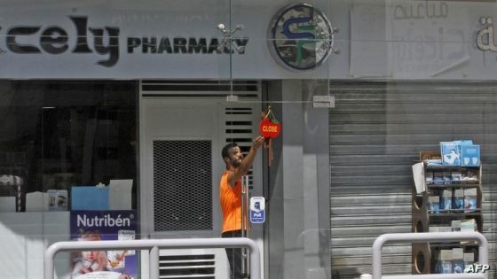 A man hangs a 'closed' sign in front of the shuttered door of a pharmacy in the southern Lebanese city of Sidon, during a nationwide strike of pharmacies to protest against a severe shortage of medicine, on July 9, 2021. - Drug importers warned that they were running out of hundreds of drugs, and that the central bank had failed to pay suppliers abroad millions of dollars in accumulated dues under a subsidy scheme. The country is facing what the World Bank has called one of the world's worst economic crises since the 1850s, and its foreign currency reserves are fast depleting. (Photo by Mahmoud ZAYYAT / AFP)