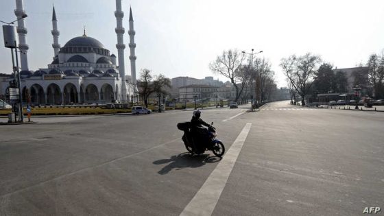 A motorcyclist crosses an empty street in Ankara during the weekend curfew to stop the spread of the novel coronavirus Covid-19 on January 09, 2021. (Photo by Adem ALTAN / AFP)