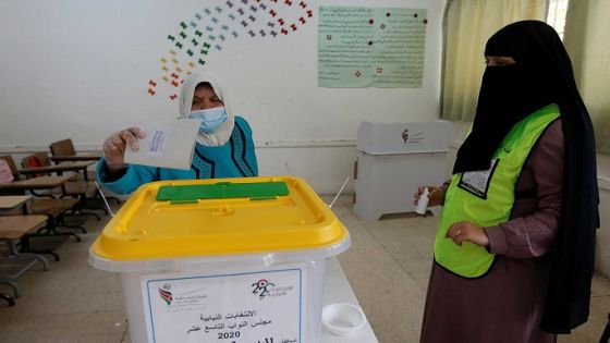 A woman casts her vote during parliamentary elections, amid fears over rising number of the coronavirus disease (COVID-19) cases, in Amman, Jordan November 10, 2020. REUTERS/Muhammad Hamed