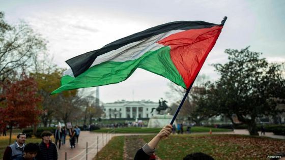 A person waves a Palestine flag at Lafayette Square during a pro-Palestinian demonstration near the White House in Washington, U.S., December 2, 2023. People gathered in solidarity after a temporary cease-fire ended between Israel and Hamas earlier this week. REUTERS/Bonnie Cash