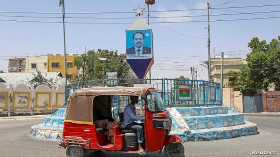 A rickshaw taxi drives past the campaign poster of Somalia's President Mohamed Abdullahi Mohamed in Mogadishu, Somalia February 8, 2021. REUTERS/Feisal Omar