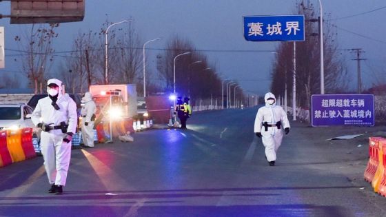 Police officers and staff members in protective suits inspect vehicles at a checkpoint on the borders of Gaocheng district on a provincial highway, following the coronavirus disease (COVID-19) outbreak in Hebei province, China January 5, 2021. Picture taken January 5, 2021. China Daily via REUTERS ATTENTION EDITORS - THIS IMAGE WAS PROVIDED BY A THIRD PARTY. CHINA OUT.