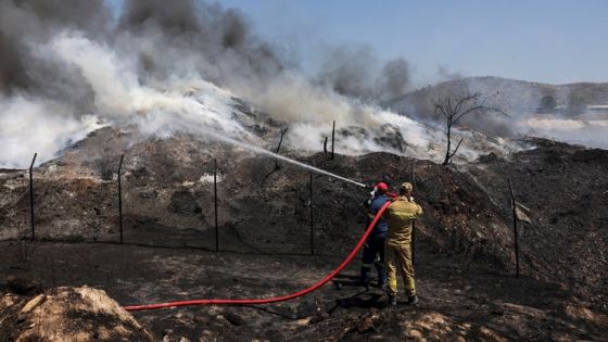 FILE PHOTO: Firefighters try to extinguish a fire burning at a recycling plant, in Sesklo, in central Greece, July 26, 2023. REUTERS/Alexandros Avramidis/File Photo