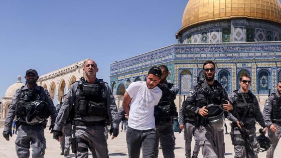 Members of the Israeli security detail a Palestinian man forces in front of the Dome of the Rock mosque, during a protest by Palestinians in response to chants by Israeli ultranationalists targeting Islam's Prophet Mohammed in the March of Flags earlier this week, following the Friday prayers, on June 18, 2021. / AFP / AHMAD GHARABLI