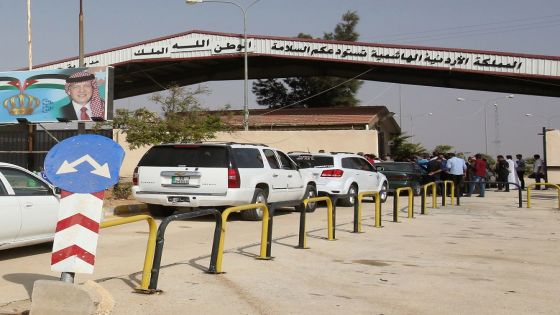 This picture taken from the Jordanian Mafraq governate on October 15, 2018, shows the Jaber border crossing between Jordan and Syria (Nassib crossing on the Syrian side) on the day of its reopening. - The main border crossing between Jordan and war-torn Syria reopened on October 15 after a three year closure, an AFP photographer reported. The black metal border gate was opened from the Jordanian side of the crossing at 8:00 am (0500 GMT) as more than a dozen police and customs officials stood nearby, the photographer said, while several cars bearing Jordanian license plates queued on the Syrian side ready to roll in. (Photo by Khalil MAZRAAWI / AFP)