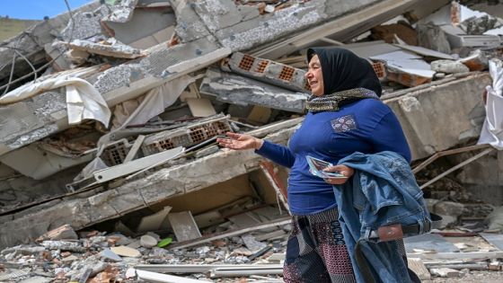 ADIYAMAN, TURKIYE - MARCH 13: Aysel Ekici, a quake survivor who lost her son and 3 grandchildren after the Kahramanmaras-centered earthquakes, searches for the belongings of her relatives under the rubbles in Adiyaman, Turkiye on March 13, 2023. On Feb.6 a strong 7.7 earthquake, centered in the Pazarcik district, jolted Kahramanmaras and strongly shook several provinces, including Gaziantep, Sanliurfa, Diyarbakir, Adana, Adiyaman, Malatya, Osmaniye, Hatay, Elazig and Kilis. On the same day at 1.24 p.m. (1024GMT), a 7.6 magnitude quake centered in Kahramanmaras' Elbistan district struck the region. (Photo by Ozkan Bilgin/Anadolu Agency via Getty Images)