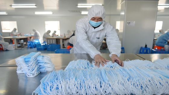 This photo taken on February 18, 2020 shows a worker sorting face masks being produced to satisfy increased demand during China's COVID-19 coronavirus outbreak, at a factory in Nanjing, in China's Jiangsu province. - The medical equipment factory switched surgical instruments and dental equipment production lines to a mask production line to meet the increased demand. (Photo by STR / AFP) / China OUT