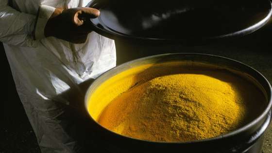 A52DBB technician with barrel of Uranium yellow cake refined from Uranium ore