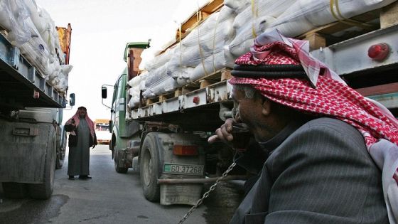 Drivers wait by their trucks loaded with humanitarian aid at the King Hussein Bridge crossing in Amman, before departing for the Gaza Strip on December 29, 2008. Israel bombed Gaza for a third day in an "all-out war" on Hamas, as tanks massed on the border and the Islamists fired deadly rockets to retaliate for the blitz that has killed nearly 320. Anger over the mammoth bombing campaign spiralled in the Muslim world, UN Secretary General Ban Ki-moon again deplored the violence, and efforts to hold talks between Syria and Israel were suspended as a result of the bombardment. AFP PHOTO/KHALIL MAZRAAWI (Photo credit should read KHALIL MAZRAAWI/AFP/Getty Images)