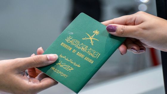 A Saudi woman receives her newly-issued passport at the Immigration and Passports Centre in the capital Riyadh on August 29, 2019. - Saudi Arabia has eased travel restrictions on women, allowing those aged over 21 to obtain passports without seeking the approval of their "guardians" - fathers, husbands or other male relatives, but observers say loopholes still allow male relatives to curtail their movements and, in the worst cases, leave them marooned in prison-like shelters. (Photo by FAYEZ NURELDINE / AFP)