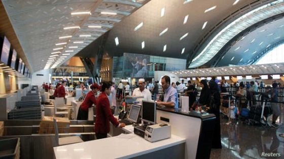 Staff members speak with passengers at Hamad International Airport in Doha, Qatar June 12, 2017. REUTERS/Naseem Zeitoon