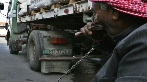 Drivers wait by their trucks loaded with humanitarian aid at the King Hussein Bridge crossing in Amman, before departing for the Gaza Strip on December 29, 2008. Israel bombed Gaza for a third day in an "all-out war" on Hamas, as tanks massed on the border and the Islamists fired deadly rockets to retaliate for the blitz that has killed nearly 320. Anger over the mammoth bombing campaign spiralled in the Muslim world, UN Secretary General Ban Ki-moon again deplored the violence, and efforts to hold talks between Syria and Israel were suspended as a result of the bombardment. AFP PHOTO/KHALIL MAZRAAWI (Photo credit should read KHALIL MAZRAAWI/AFP/Getty Images)