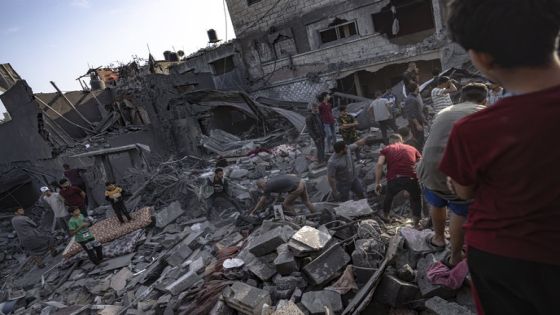 Palestinians look for survivors of the Israeli bombardment in the Maghazi refugee camp in the Gaza Strip, Sunday, Nov. 5, 2023. (AP Photo/Fatima Shbair)