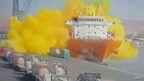 This image grab taken from a CCTV footage broadcasted by Jordan's Al-Mamlaka TV on June 27, 2022 shows the moment of a toxic gas explosion in Jordan's Aqaba port. - Footage on state TV showed a large cylinder plunging from a crane on a moored vessel, causing a violent explosion of yellow gas. The government spokesman urged citizens not to approach the site of the accident, adding that medical reinforcements were being sent to Aqaba. (Photo by various sources / AFP) / RESTRICTED TO EDITORIAL USE - MANDATORY CREDIT "AFP PHOTO /AL MAMLAKA TV " - NO MARKETING - NO ADVERTISING CAMPAIGNS - DISTRIBUTED AS A SERVICE TO CLIENTS