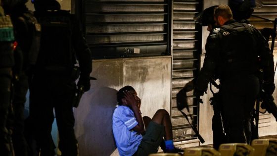 Police identify a young person during the fifth night of protests following the death of Nahel, a 17-year-old teenager killed by a French police officer in Nanterre during a traffic stop, in the Champs Elysees area, in Paris, France, July 2, 2023. REUTERS/Juan Medina REFILE-QUALITY REPEAT